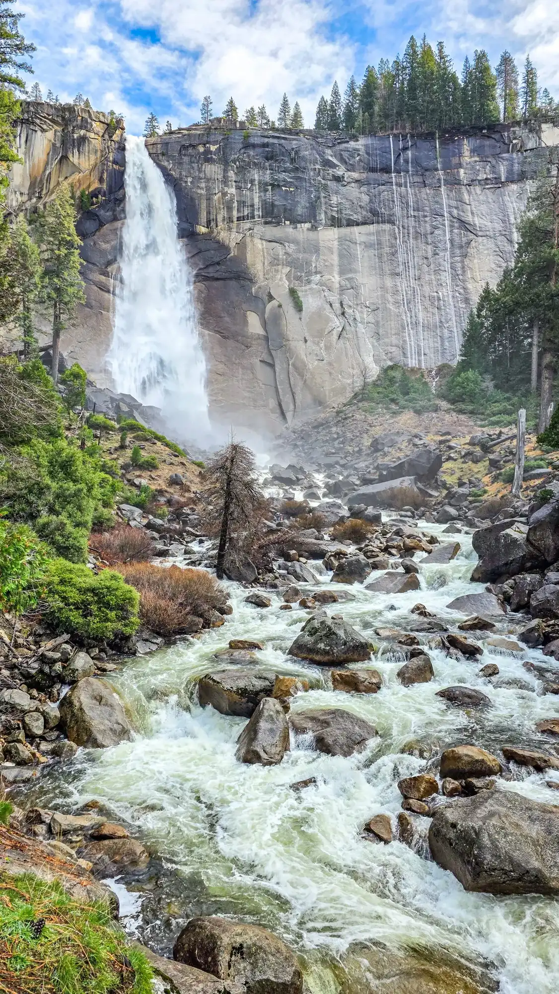 Nevada Fall waterfall on Mist Trail with Merced River flowing over granite cliffs and boulder field below