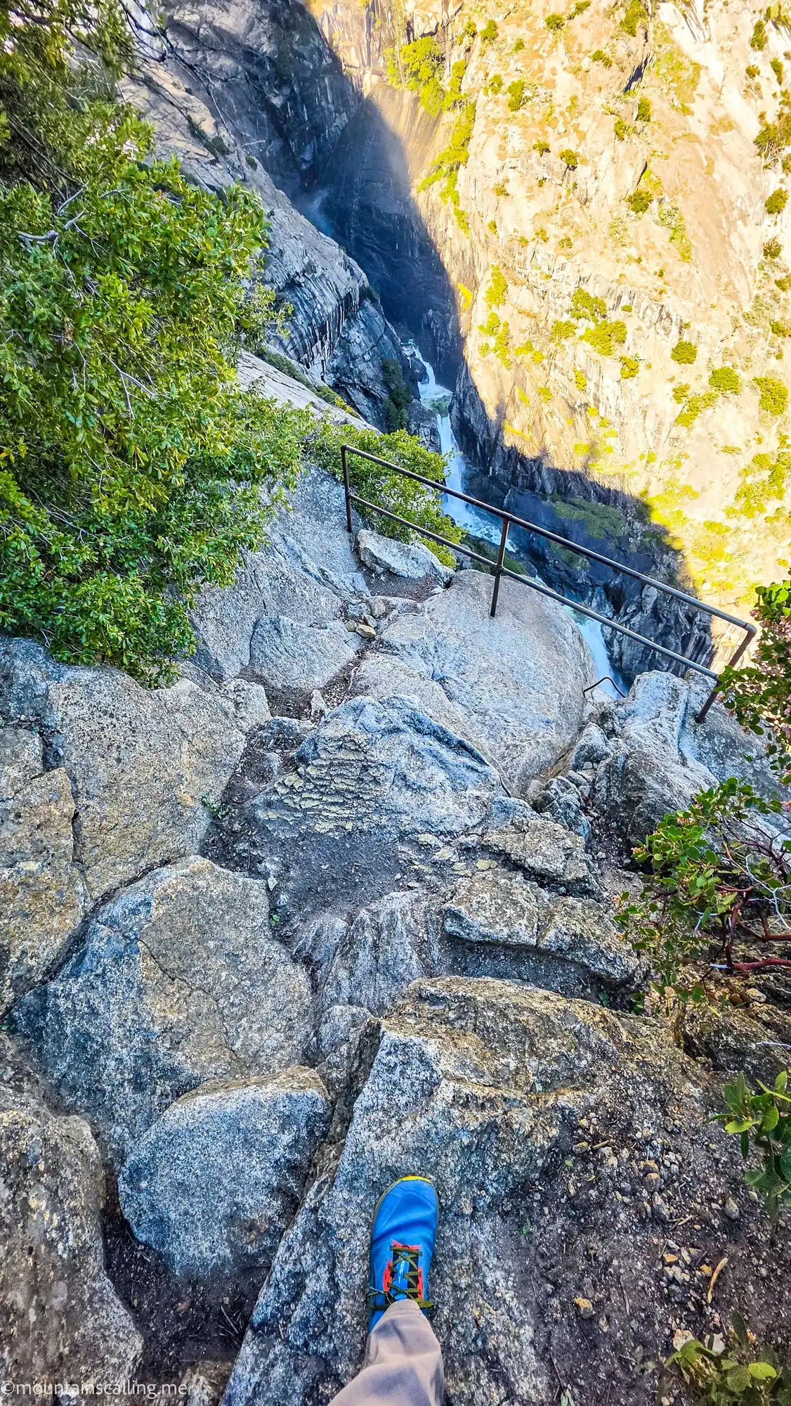 Steep rocky trail descent to OMG Point with metal handrail and granite canyon walls