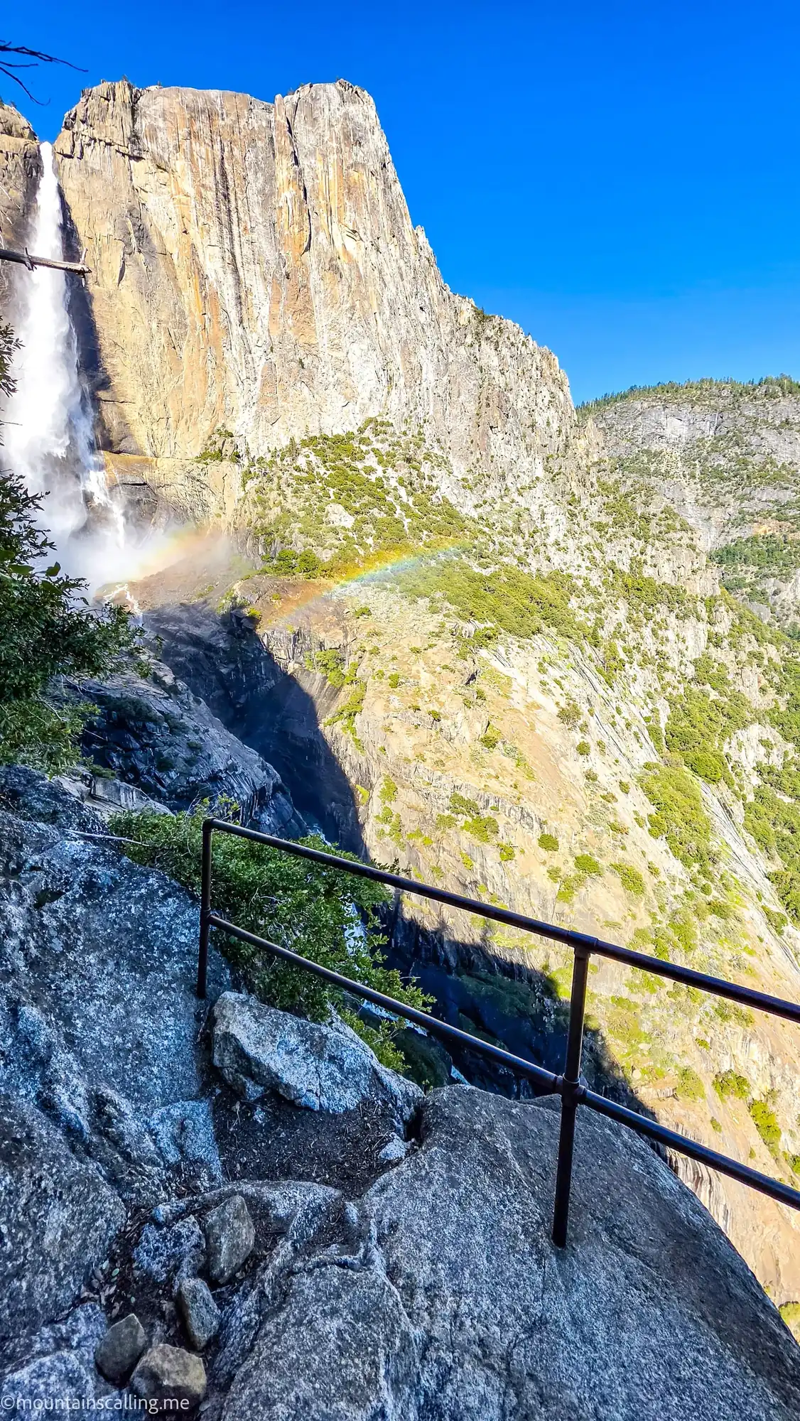 Rainbow over Upper Yosemite Fall from OMG Point with granite cliffs and valley walls