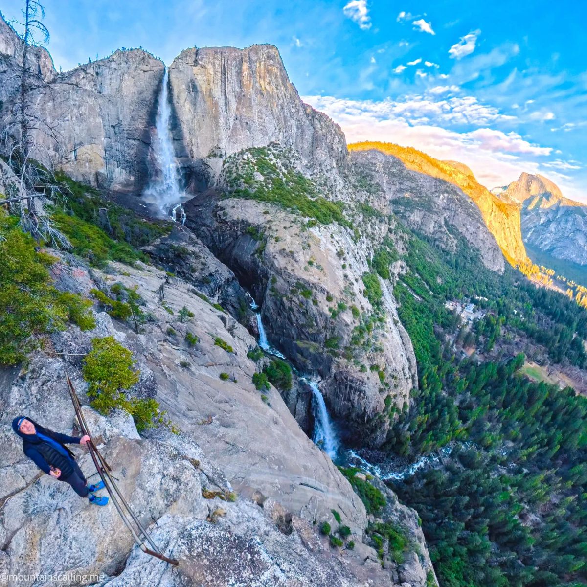 Hiker at OMG Point overlooking Yosemite Falls and Half Dome at sunset with golden light on granite cliffs