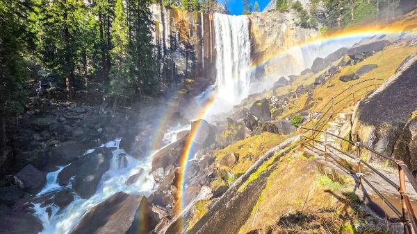 Double rainbow through mist spray on Mist Trail granite steps near Vernal Fall in Yosemite National Park