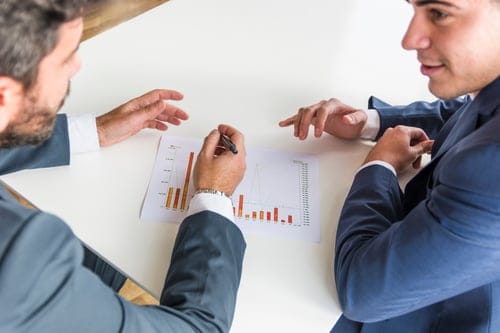 close-up-businessmen-working-company-financial-report-white-desk
