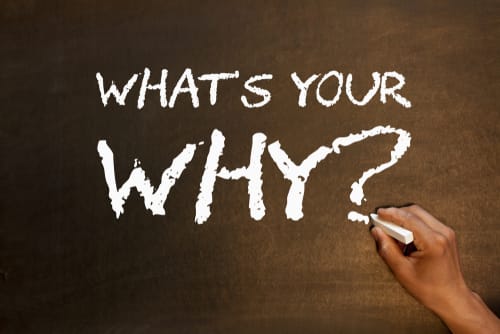 Image showing a hand writing "what's your why"