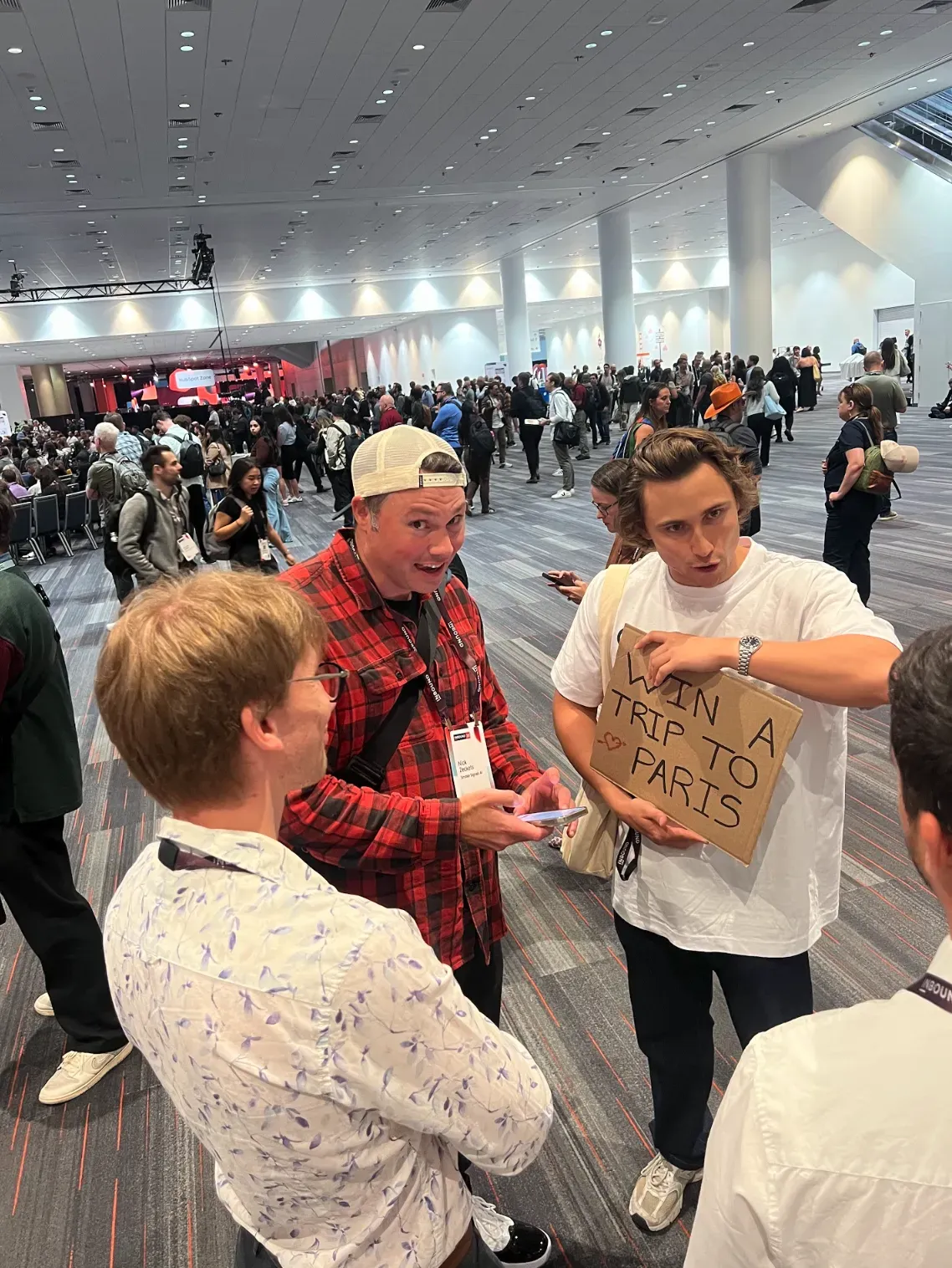 Photo of someone holding up a sign and engaging people at HubSpot's Inbound