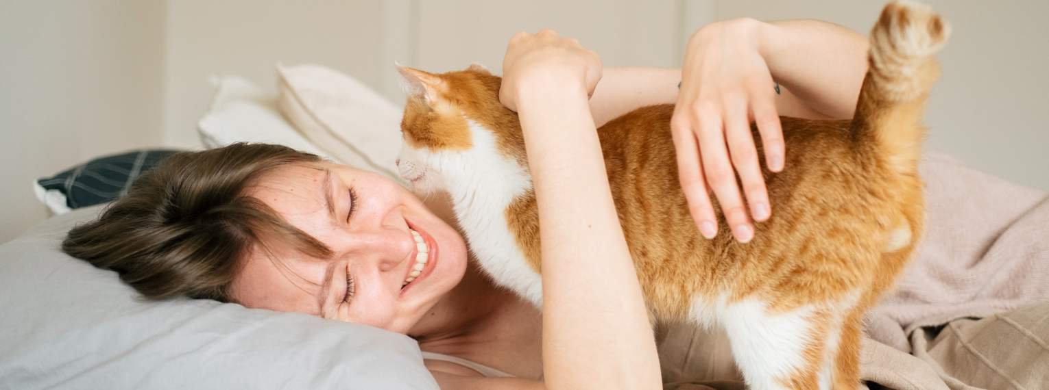 Eine Frau umarmt ihre Katze.