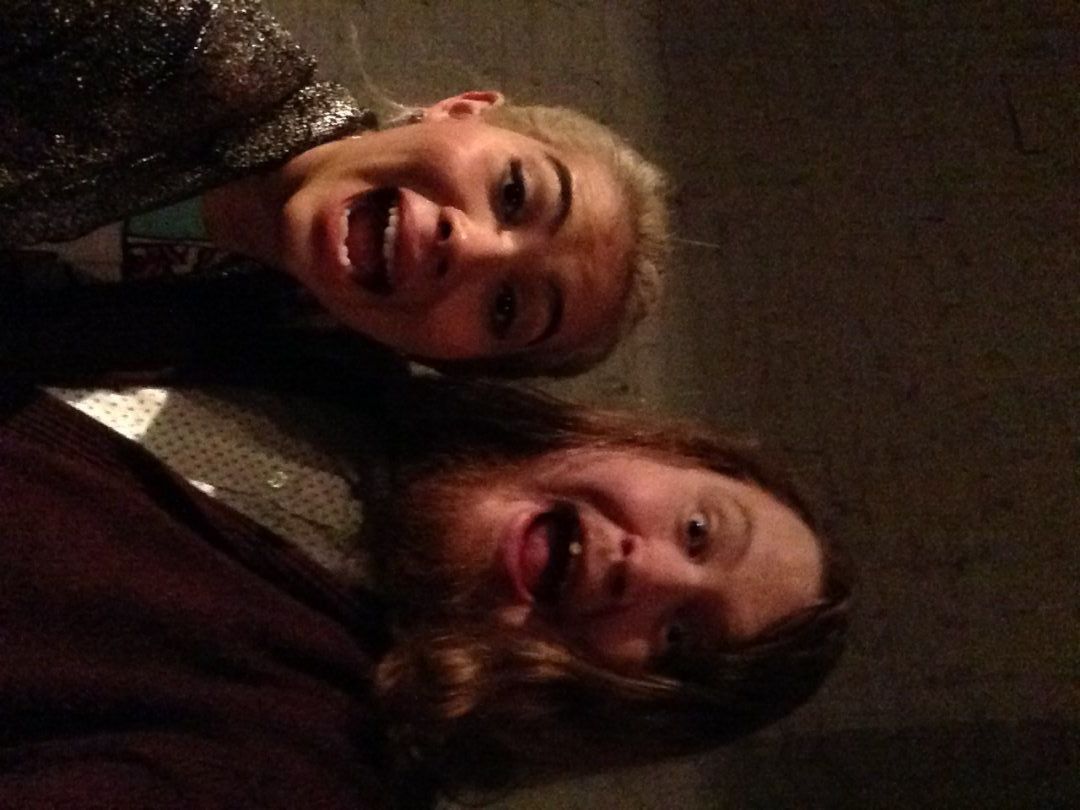 Hayley Kiyoko and Luke Sheafer take a selfie behind the mercy booths after Never Shout's set in Lansing.