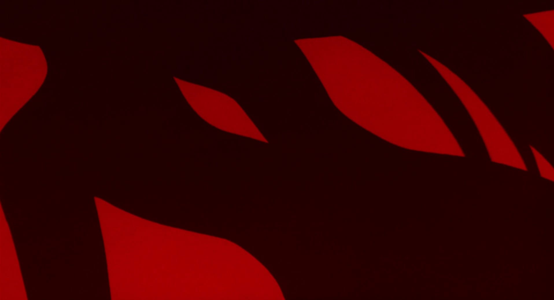 a hole in a black silhouette against a red background