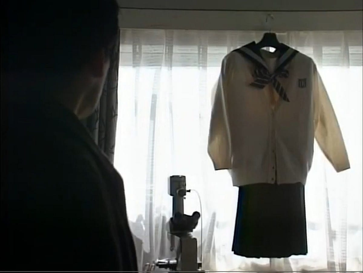 hamura, seen from behind, stares at a girl's school uniform hanging in the window next to a microscope
