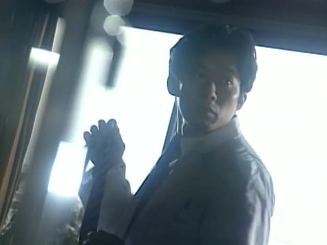 hamura stands in front of a glass window