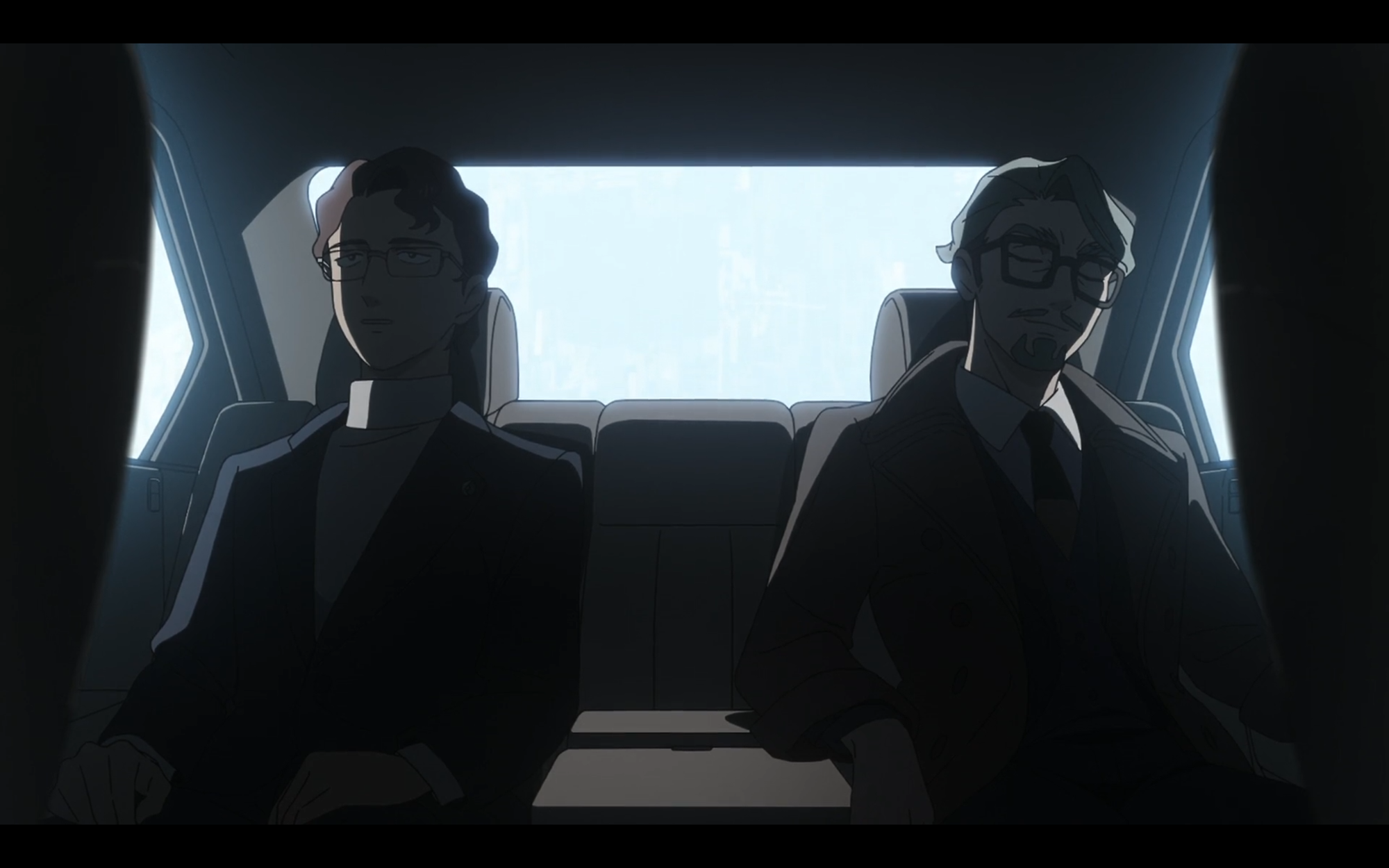 cameron bloom and chalia bull sit side by side in the back seat of a car. they are looking away from each other and are shrouded in shadow