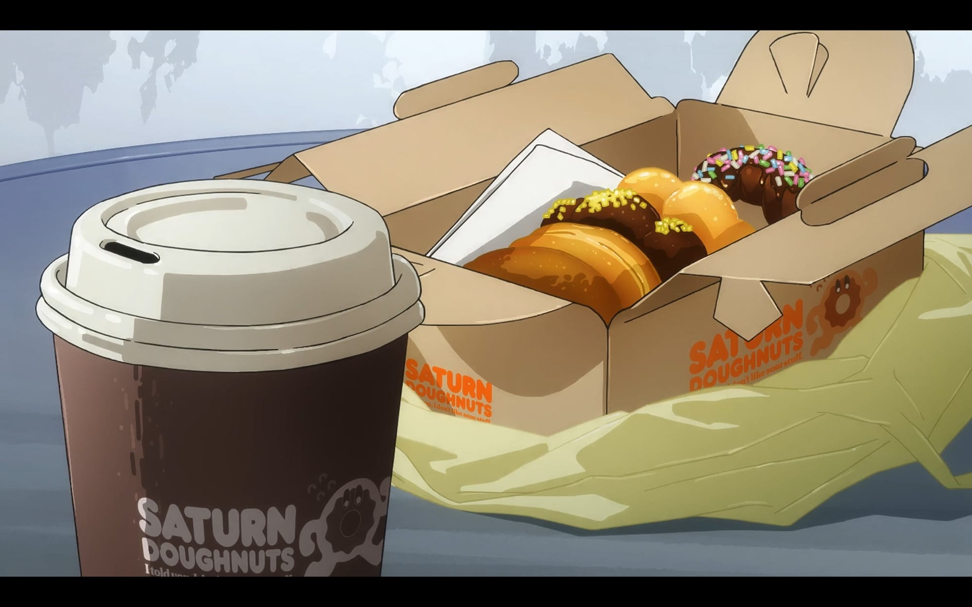 a box of saturn doughnuts and coffee.
