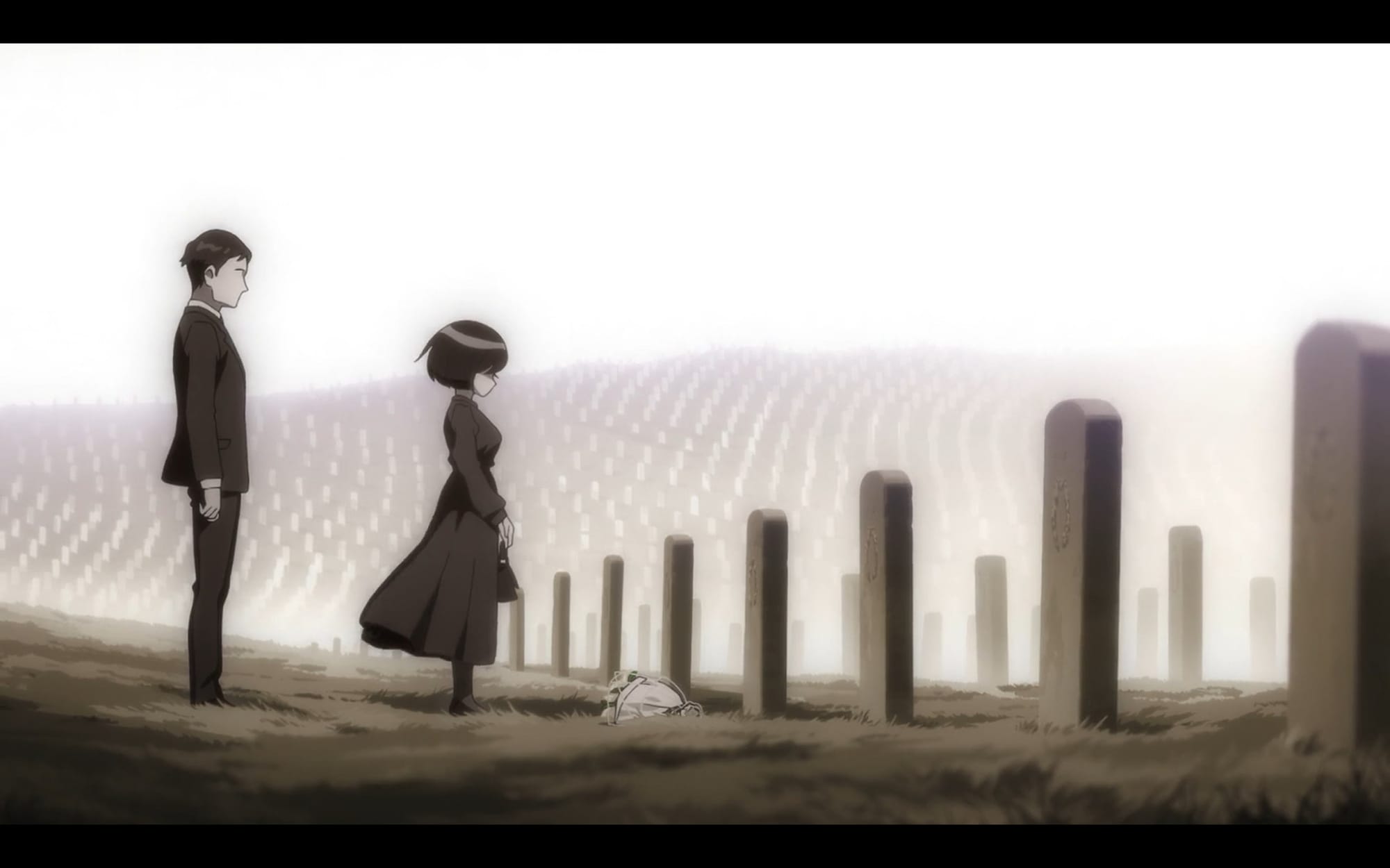 a woman wearing a black dress stands with flowers by a grave in a field of graves. a man stands behind her.