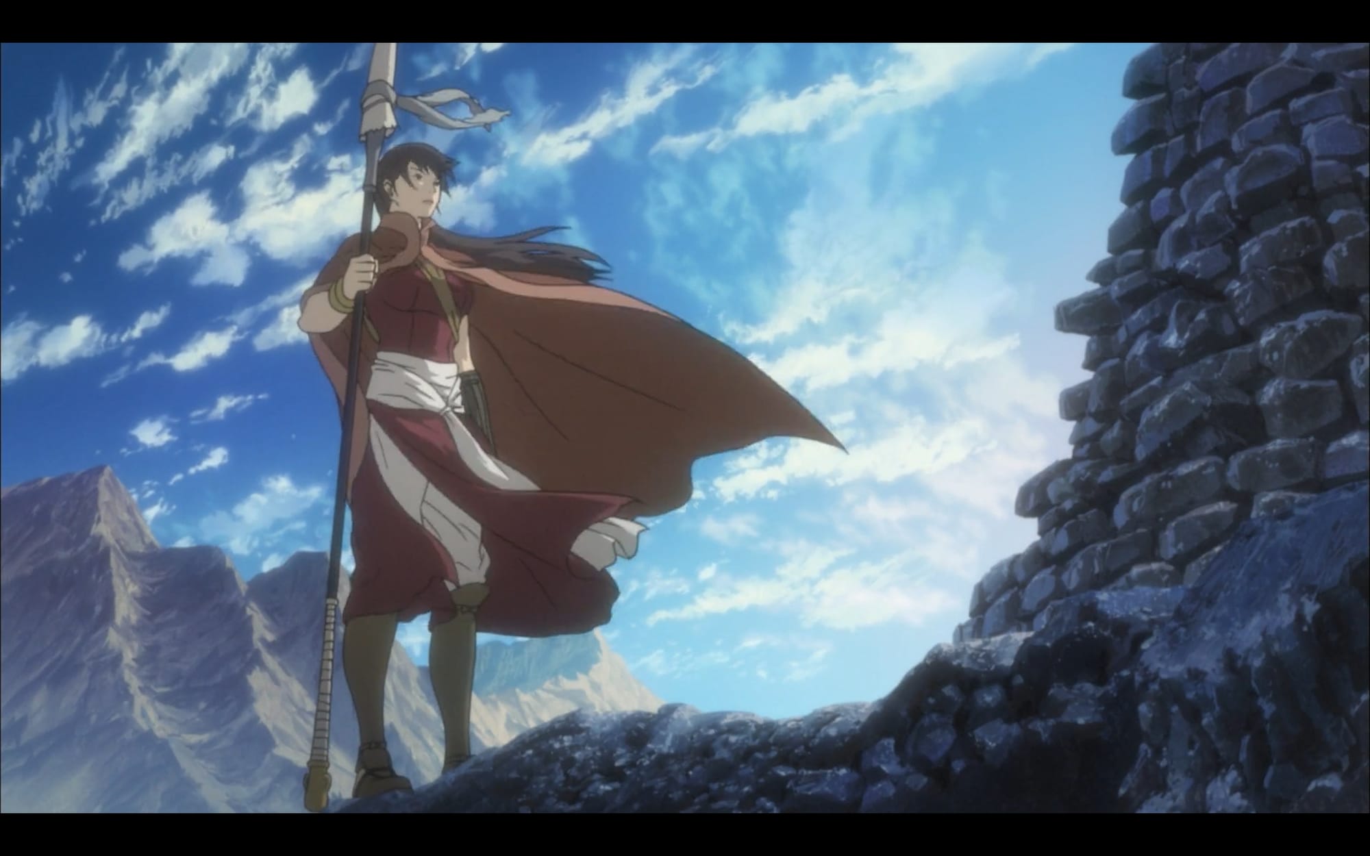 balsa, a woman holding a spear, stands in the mountains