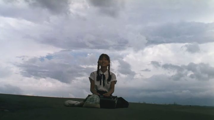 girl sitting in field