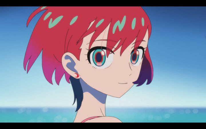 machu, standing by the ocean, looks at the audience