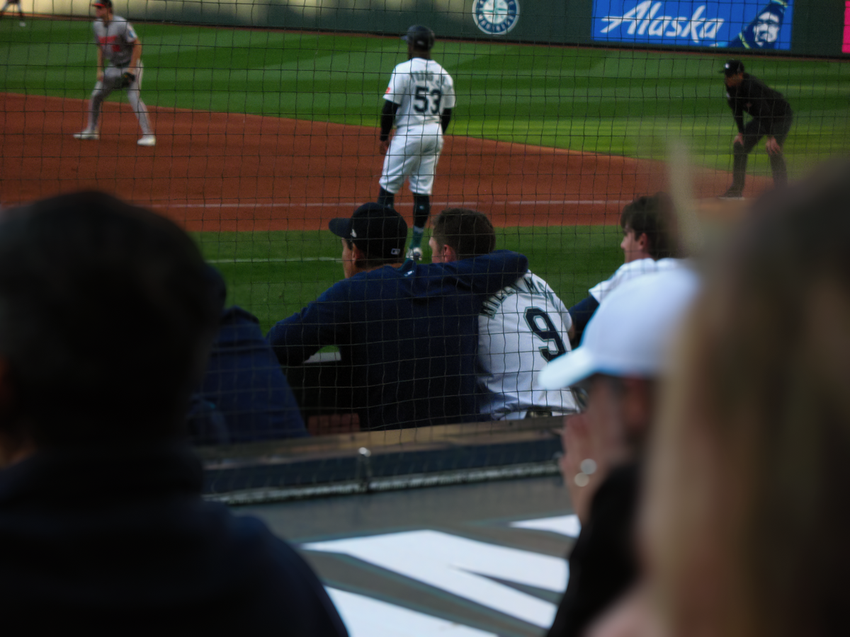 Mariners manager Dan Wilson and third baseman Ben Williamson in the dugout at T-Mobile Park looking at the field during a game against the Baltimore Orioles.