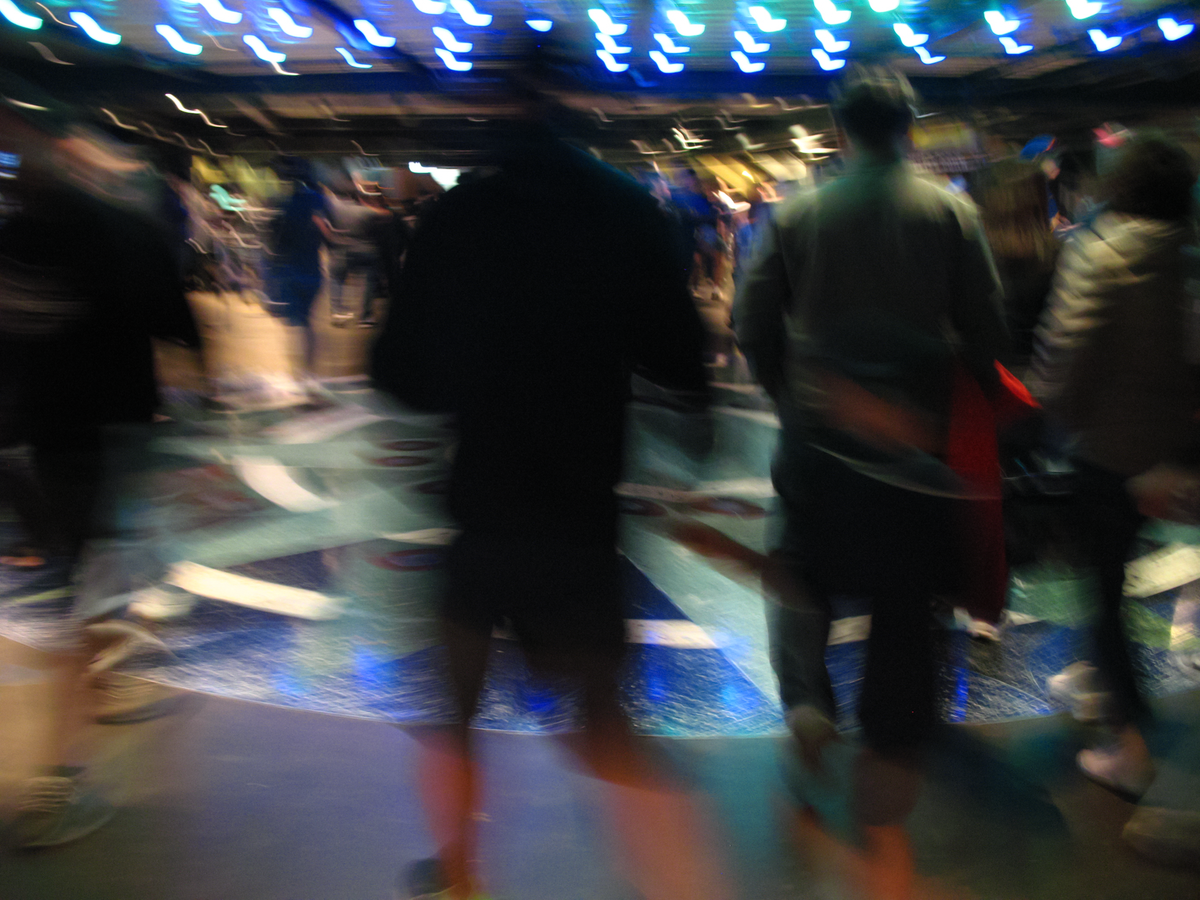 An extremely blurry image of people walking around inside T-Mobile Park.