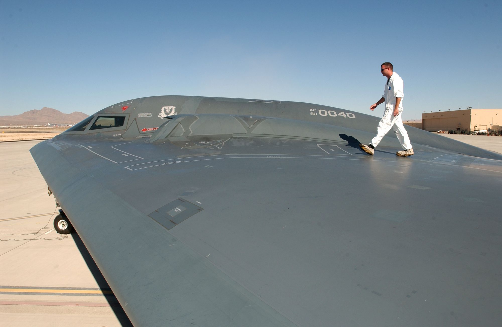 Sgt. Kevin Ponton examines the wing surface of a B-2 Spirit Bomber