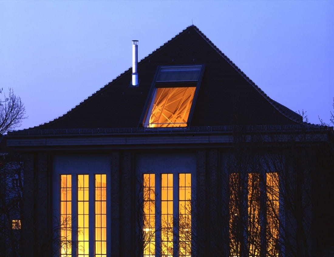 Roof and window detail of the converted pumping station at dusk.
