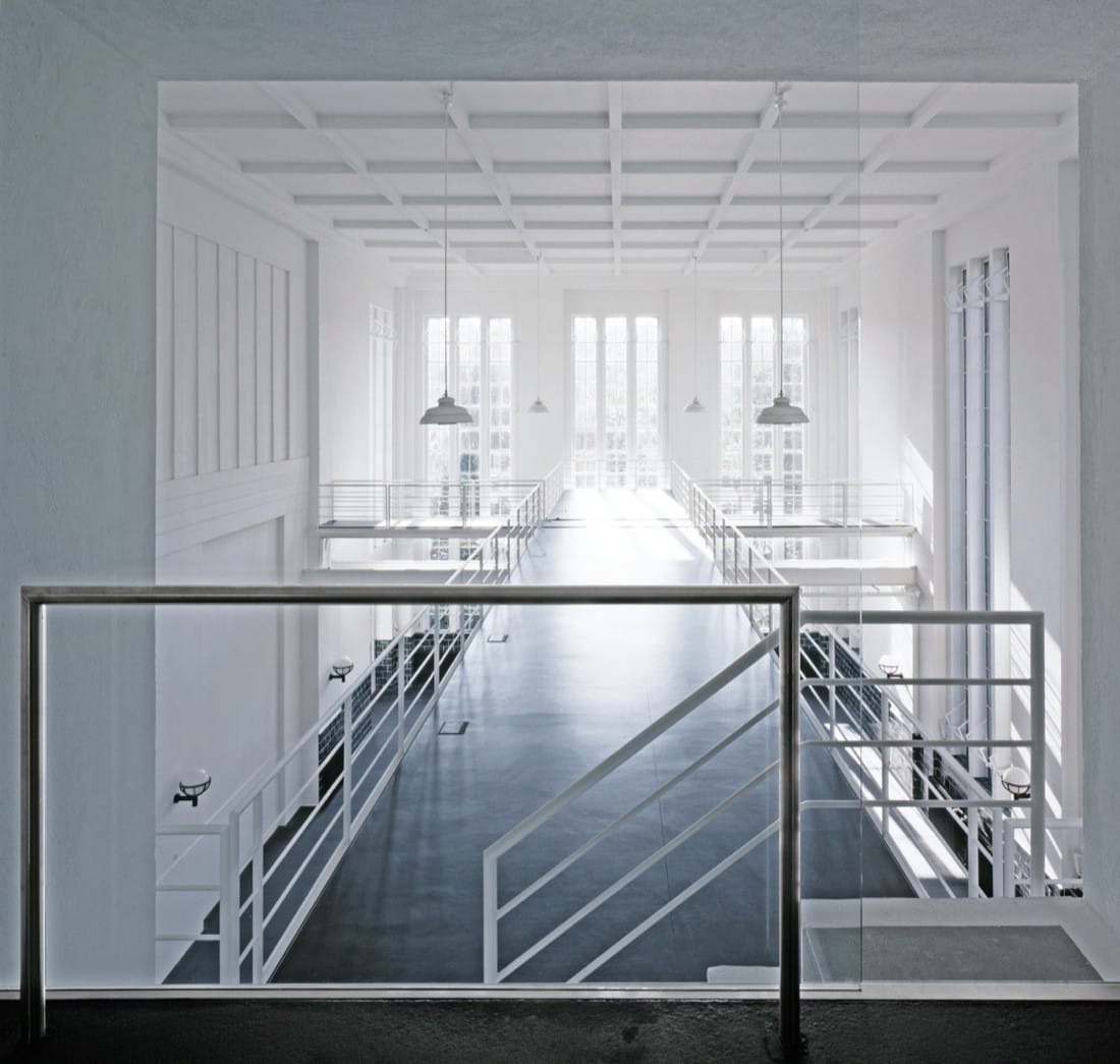 Mezzanine walkway and white interior volume above the pumping station hall.