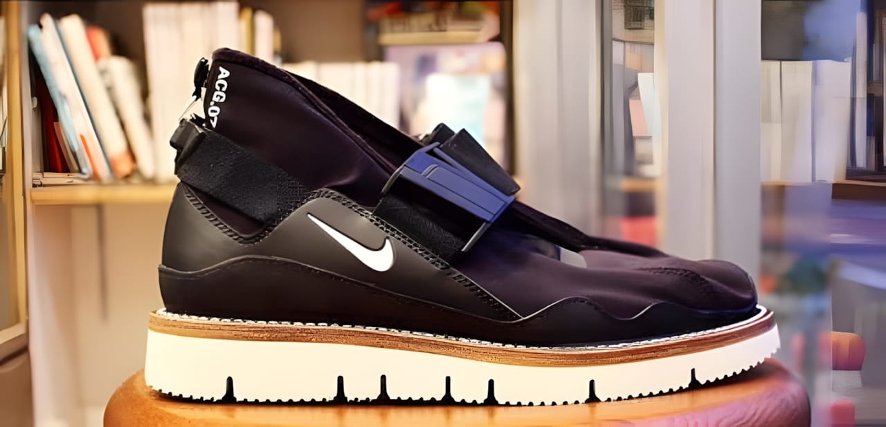 Nike Komyuter AA2211-001 lateral profile showing magnetic buckle strap and gum outsole