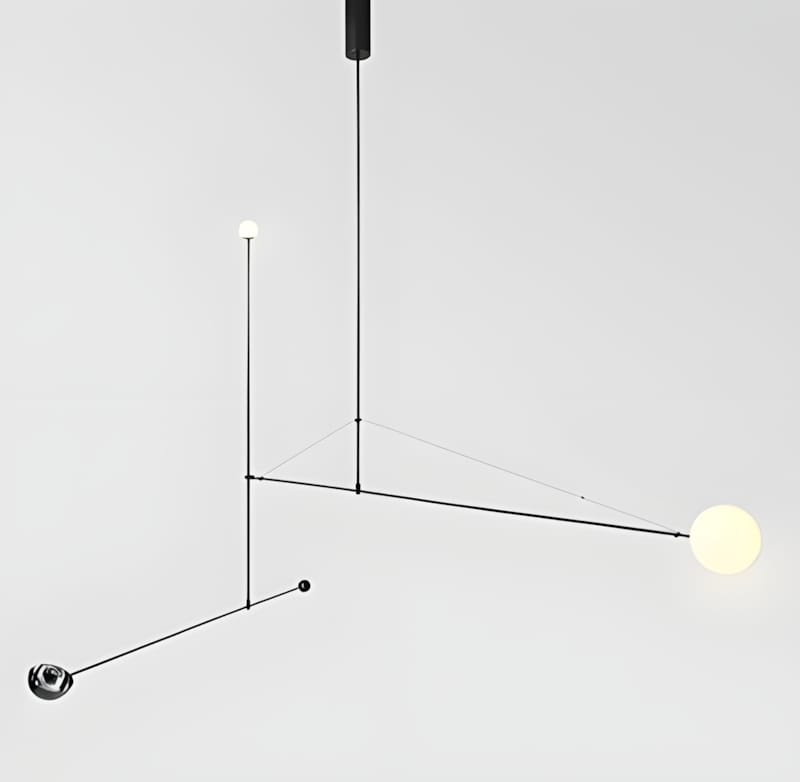 Michael Anastassiades Mobile Chandelier — asymmetric black brass rod composition with two globe bulbs, counterweight sphere, and wire tension, shot against grey ground.