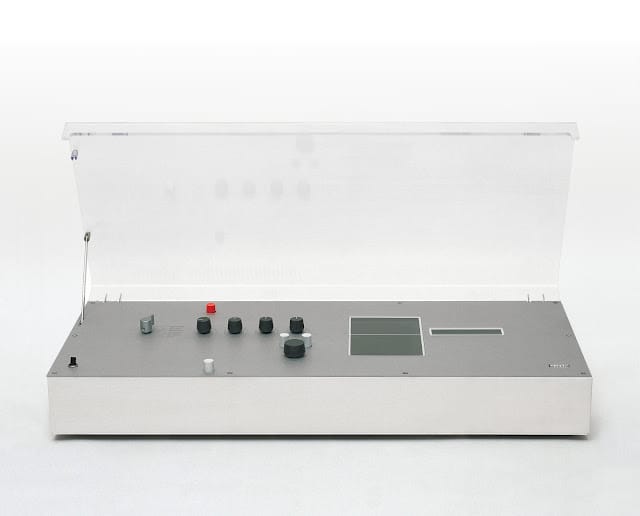Braun Audio 310 hi-fi console (1971) designed by Dieter Rams — flat low-profile integrated stereo system with clear acrylic dust cover raised, white/silver housing, grey controls and multiple black knobs
