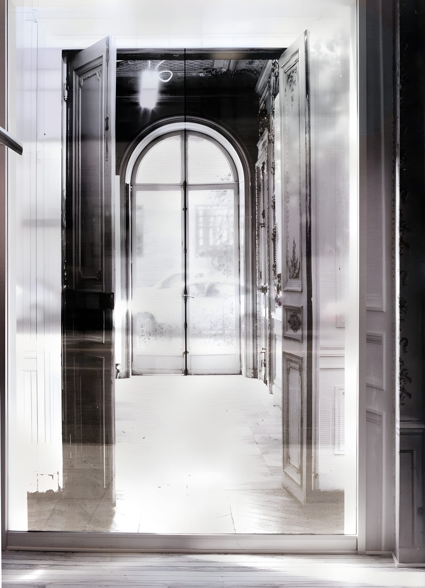 An overexposed classical arched corridor inside Maison Martin Margiela’s Paris headquarters at 163 rue Saint-Maur.