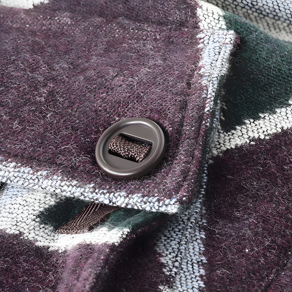 Close-up of barrel-toggle button closure on Kapital diamond-pattern wool fabric