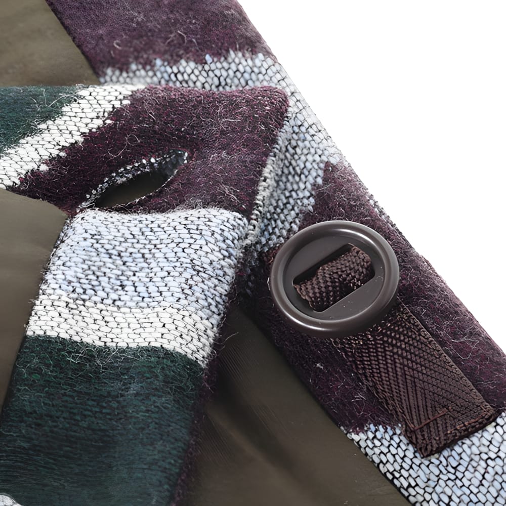 Button and seam construction detail on Kapital harlequin wool skirt showing olive canvas lining