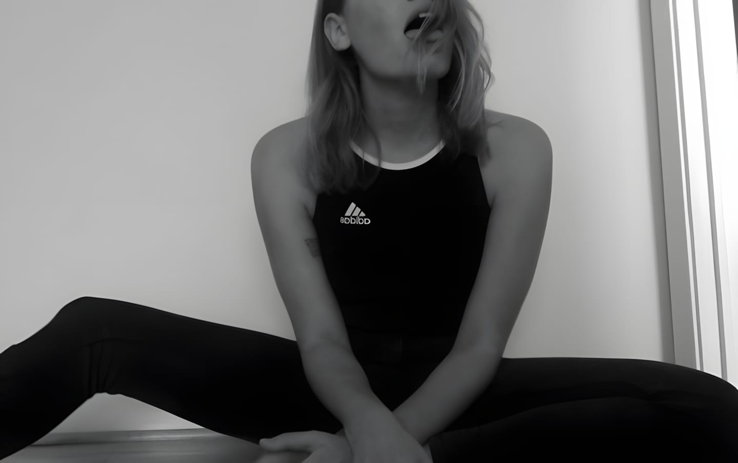Second frame: woman in black Adidas performance tank top, B&W editorial