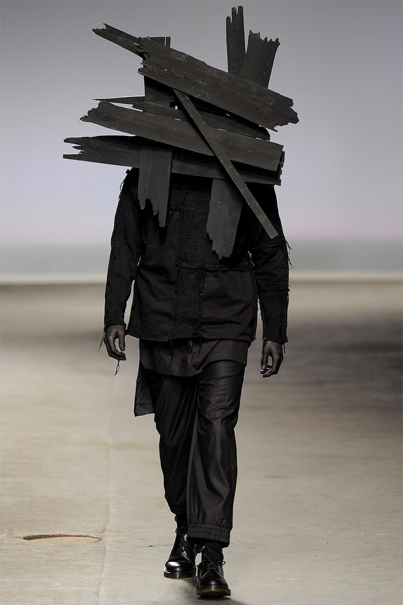 Craig Green FW2013 MAN look 1 — white layered cotton separates with oversized silhouette and sculptural wooden plank headdress