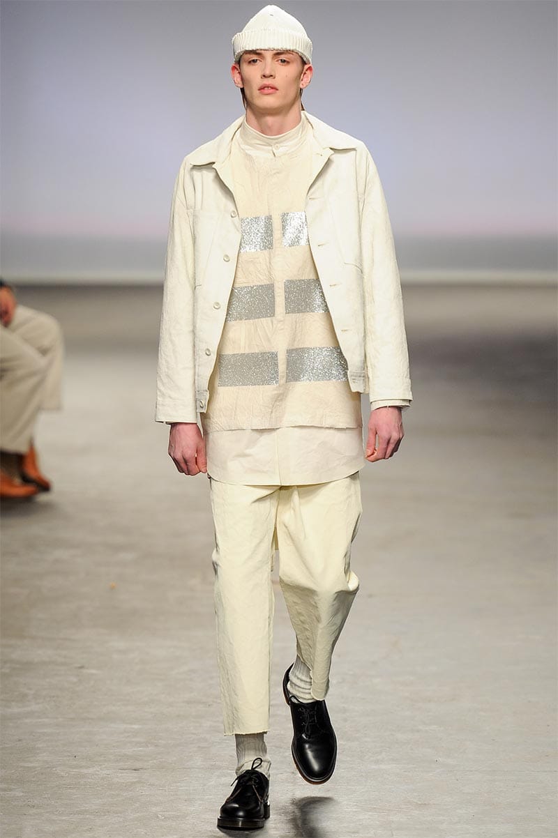 Craig Green FW2013 MAN look 13 — white satin overshirt and wide-leg trousers with cut-off rolled hem and plank headdress