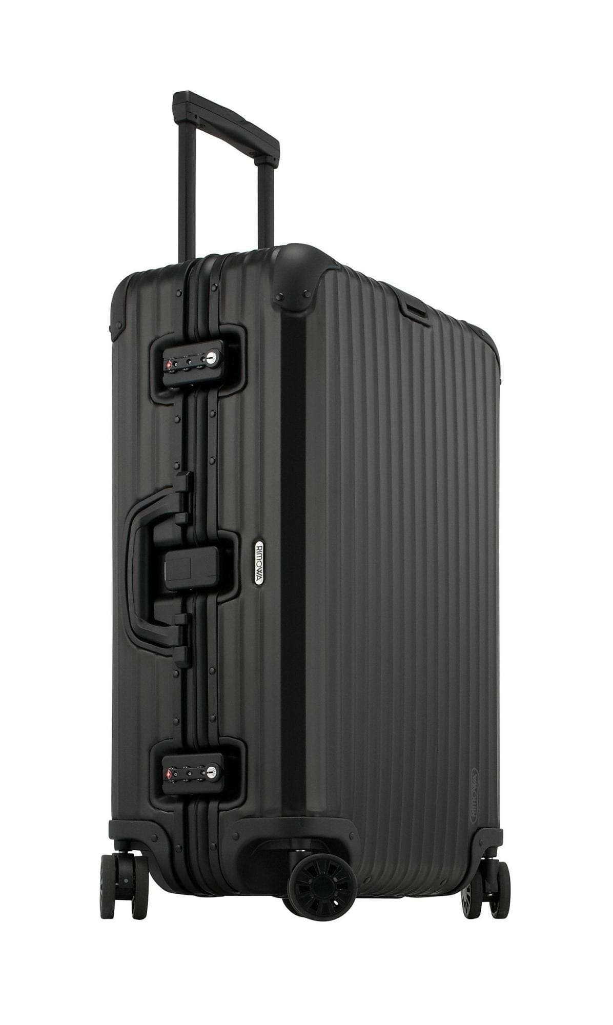 Side profile of the black Rimowa Topas Stealth showing the full-length grooved aluminium shell.