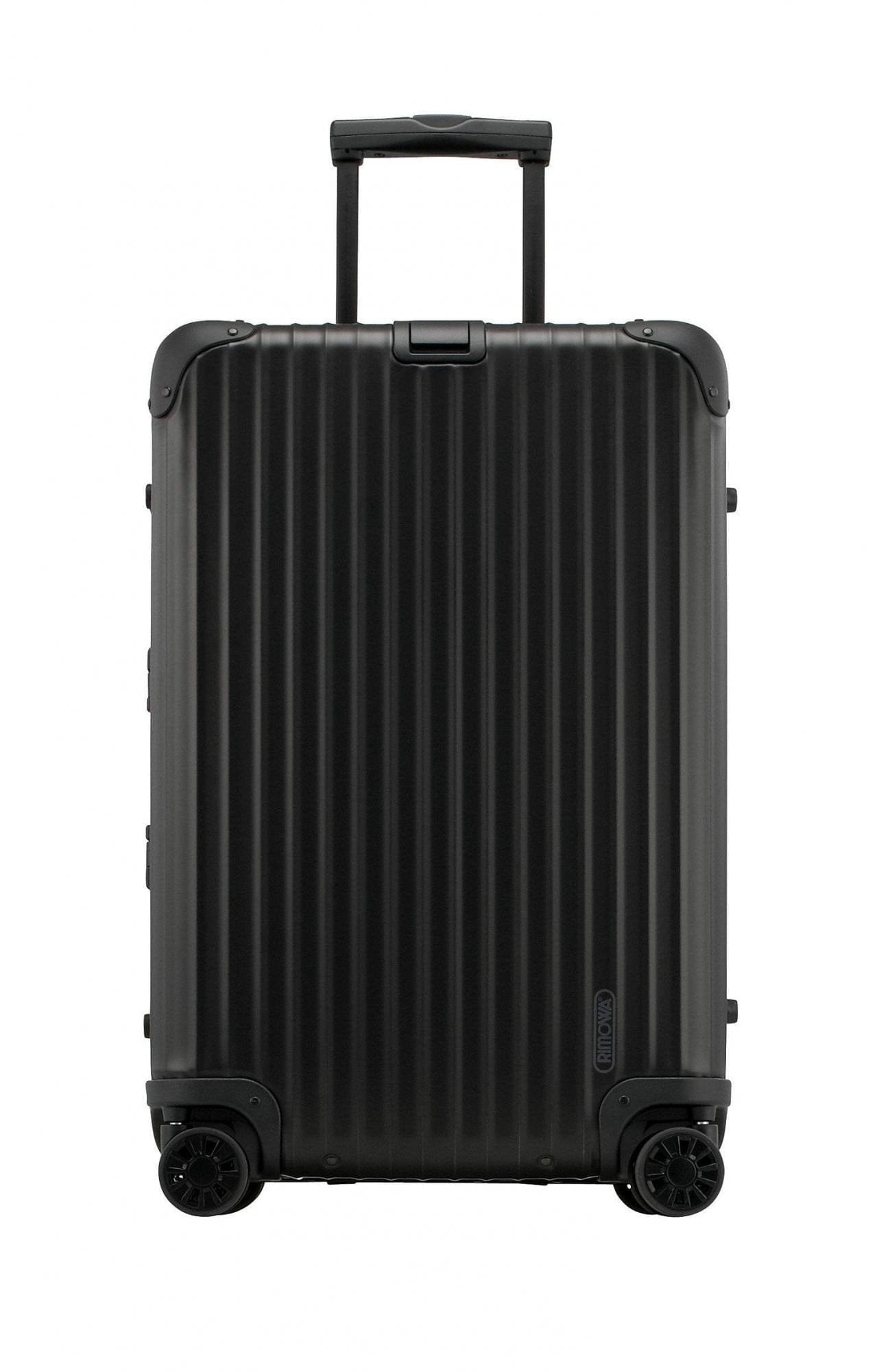 Front view of the black Rimowa Topas Stealth: grooved anodized-aluminium face, RIMOWA logo and four spinner wheels.
