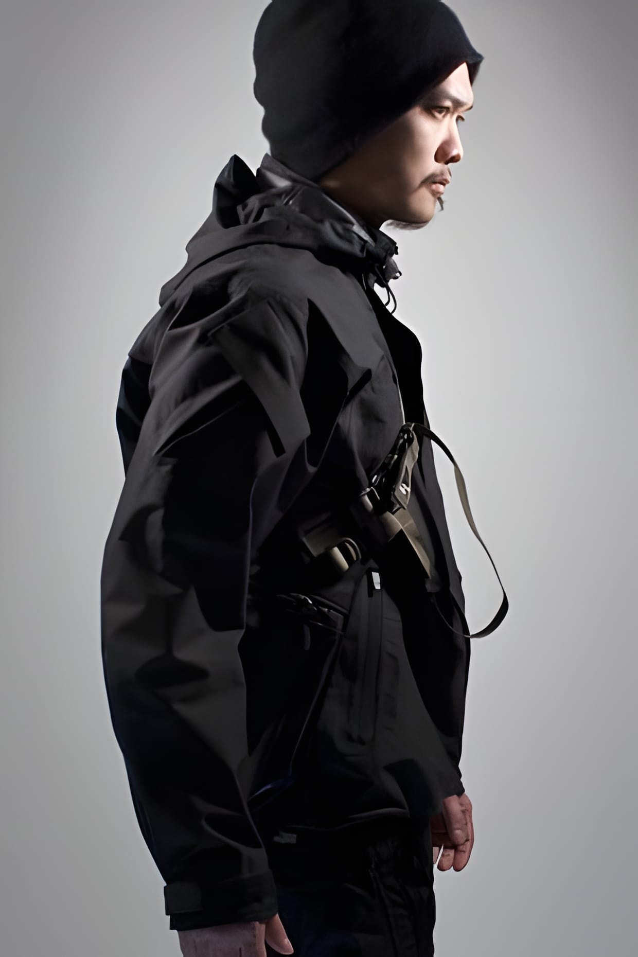 ACRONYM 2009 Fall/Winter black hooded hardshell jacket worn, side profile.
