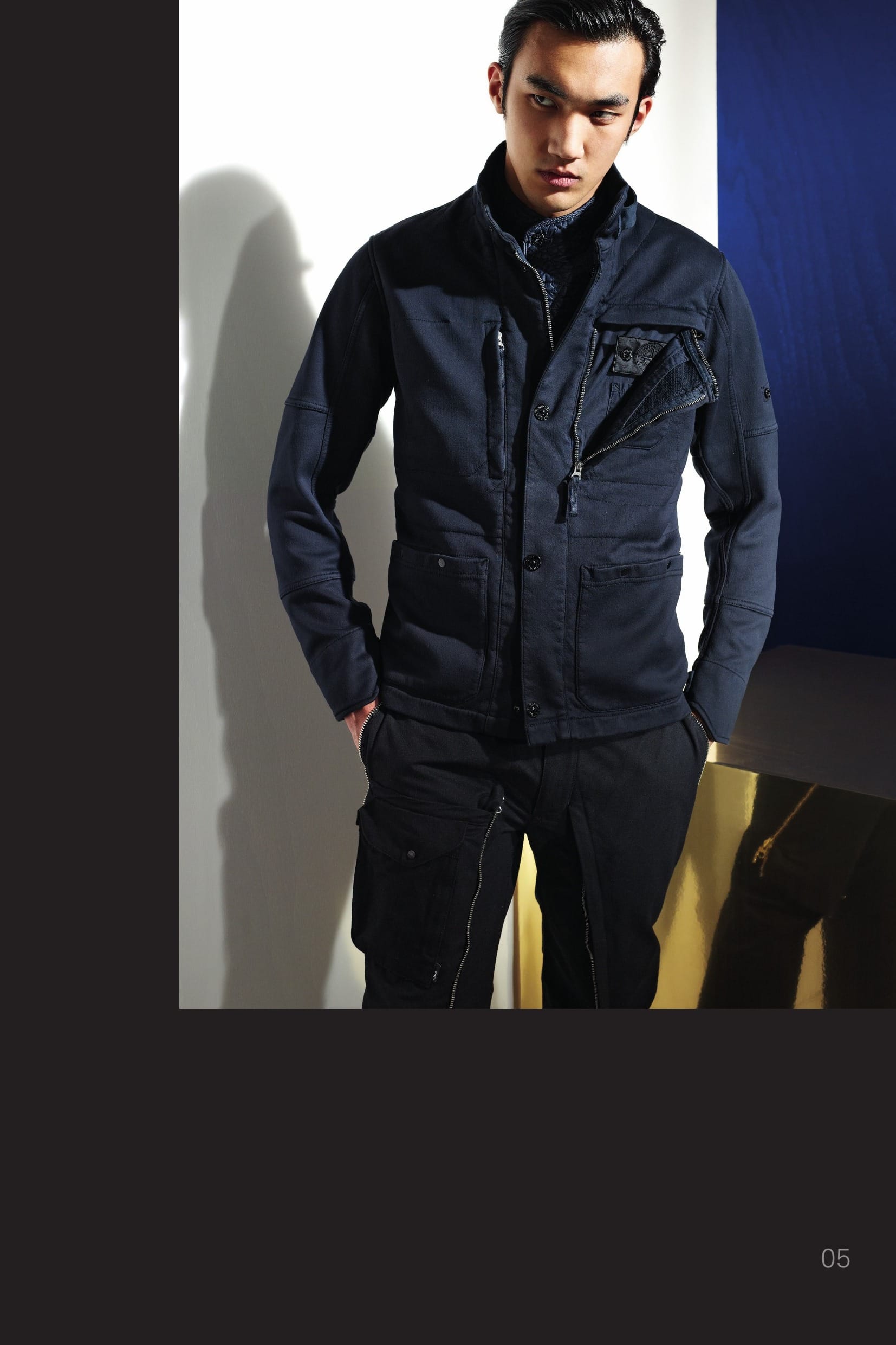 41007 CATEGORY_RESIST _ BLAZER_ JERSEY-R 3L [ BONDED JERSEY MAKO AND FLEECE ] Developed exclusively for STONE ISLAND SHADOW PROJECT, JERSEY-R takes softshell fabrics to a new level of elegance and comfort. Its 3-ply composite construction bonds a windproof waterproof breath- able membrane between face and backers of finest mercerized cotton jersey and fleece. Incredibly soft and fluid, the fabric’s tactile qualities belie its very real protective attributes. Combined with the STONE ISLAND garment dye process, Jersey-R garments ex- ude ease and refinement beyond the range of normal performance apparel. _ Optimal weather protection: Waterproof and windproof _ Breathable: Allows moisture vapour to escape _ Exceptional comfort and wearability _ Garment dyed with the addition of an anti-drop agent Two patch pockets with snaps fastening on front. On the chest, one single pocket with vertical hidden zip fastening on the right side. On the left side, a vertical and horizontal hidden zip fastening hides an array of inner pockets and the STONE ISLAND badge; small patch pocket on the outer surface. Ergonomic sleeve construction. Shaped cuff with strap and adjustable snap fastening. Back vents on shoulders. Raised collar in finely ribbed cotton jersey, with strap and adjustable snap fastening. Snaps and hidden zip fastening. 30412 CATEGORY_ RESIST _ CONVERT PANT [NYCO MOLESKIN ] Cotton nylon moleskin trousers. On the legs, two large flaps with one double pull zip fastening on each side can be folded inside large leg pockets: the outer zips, if opened from the top, act as pocket ‘entrance’ to the trousers side pockets hidden below. The leg pockets carry and array of smaller pockets closed by flaps and snaps. One of these pockets is closed by a vertical Velcro® fastening hiding the STONE ISLAND SHADOW badge. Zip and snap fly fastening.