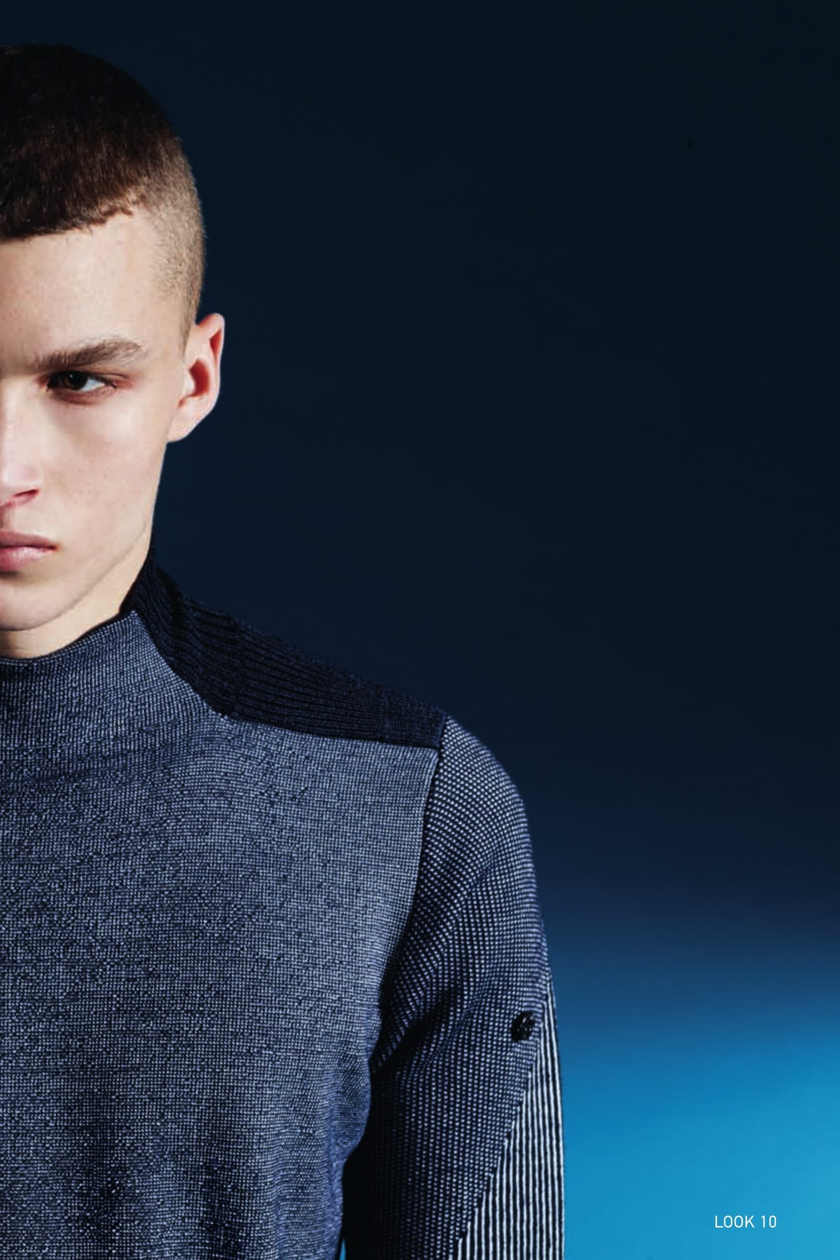 502A1 TURTLE NECK_WO/PL/PA JACQUARD State of the Art in knitwear construction. Mock turtle neck knit in a blend of wool, polyester and polyamide yarns seamlessly woven with a combination of jacquard and placed intarsia techniques.