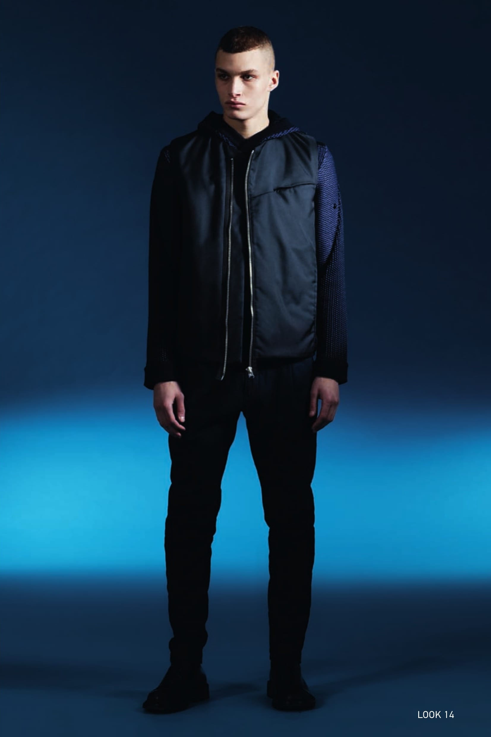 G0206 ASYM ZIP VEST_STRUCTURED NYLON RESINATO Vest in a micro structured nylon with a shiny matte appearance and internal resin treatment to create light water resistance. Tapes and snap fasteners at the neck allow the garment to be integrated in Stone Island Shadow Project shoulder pieces, both from this season and past and future seasons. Vertical side pockets. Small flat pocket slightly on the diagonal on the chest, hidden by a flap. Rounded bottom hem, with back insert in the same fabric and Stone Island Shadow Project badge partially concealed by a flap. The inner face is lined with a lightweight iridescent nylon quilted with a star-pattern to a padding substrate on the upper part. Slightly asymmetrical metal zip fastening. 504A1 HOODED JACKET_WO/PL/PA JACQUARD State of the Art in knitwear technique. Hooded cardigan in a blend of wool, polyester and polyamide yarns seamlessly woven with a combination of jacquard and placed intarsia techniques. Seamless pocket construction. Slightly off-centre black zip fastening with buttons underneath. 30505 NARROW PLEATED PANT _LANA/LINO/NYLON Trousers with single dart in brushed wool/ linen/nylon twill fabric. Specific double garment dyeing recipes allow superb colour and multi-tone depth to this triple composition fabric. Diagonal side pockets. Two back pockets with flap and button fastening. Stretch jersey insert on bottom hem of leg. Zip fly and button at the waist.