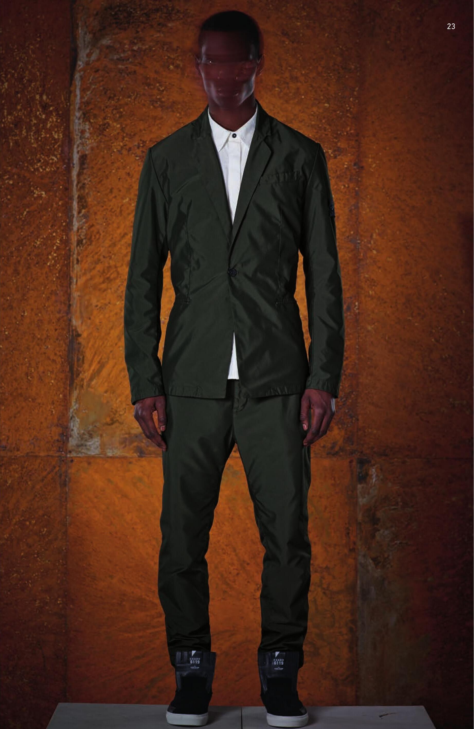 A0305 SB BLAZER _ DIAGONAL PL Single breasted blazer in shiny diagonal weave polyester. Garment dyed under pressure at 130°. Notched lapels with squared indent. Two cuts on the front on the front of the blazer. Small welt pocket on the chest. Welt pockets on the front. On the left sleeve, the Stone Island Shadow Project badge is partly concealed by a flap. Hidden button fastening cuffs. Two back slits. Half lining in technical nylon mesh and small vertical zip fastened pocket in the inside. 10117 CLASSIC SHIRT _ NYCO SATIN PA/CO Shirt in NYCO, nylon/cotton satin. Chest pocket with opening hidden by fabric appliqué creating a fold. Garment dyed. Buttons at cuffs. Buttons hidden by placket. 30105 HIGH WAISTED CHINO _ DIAGONAL PL Chino trousers in shiny diagonal weave polyester. Slightly high waist cut. Vertical opening pockets parallel to the dart. Horizontal opening back pockets, inserted into the yoke. Zip fastening. Garment dyed under pressure at 130°C.