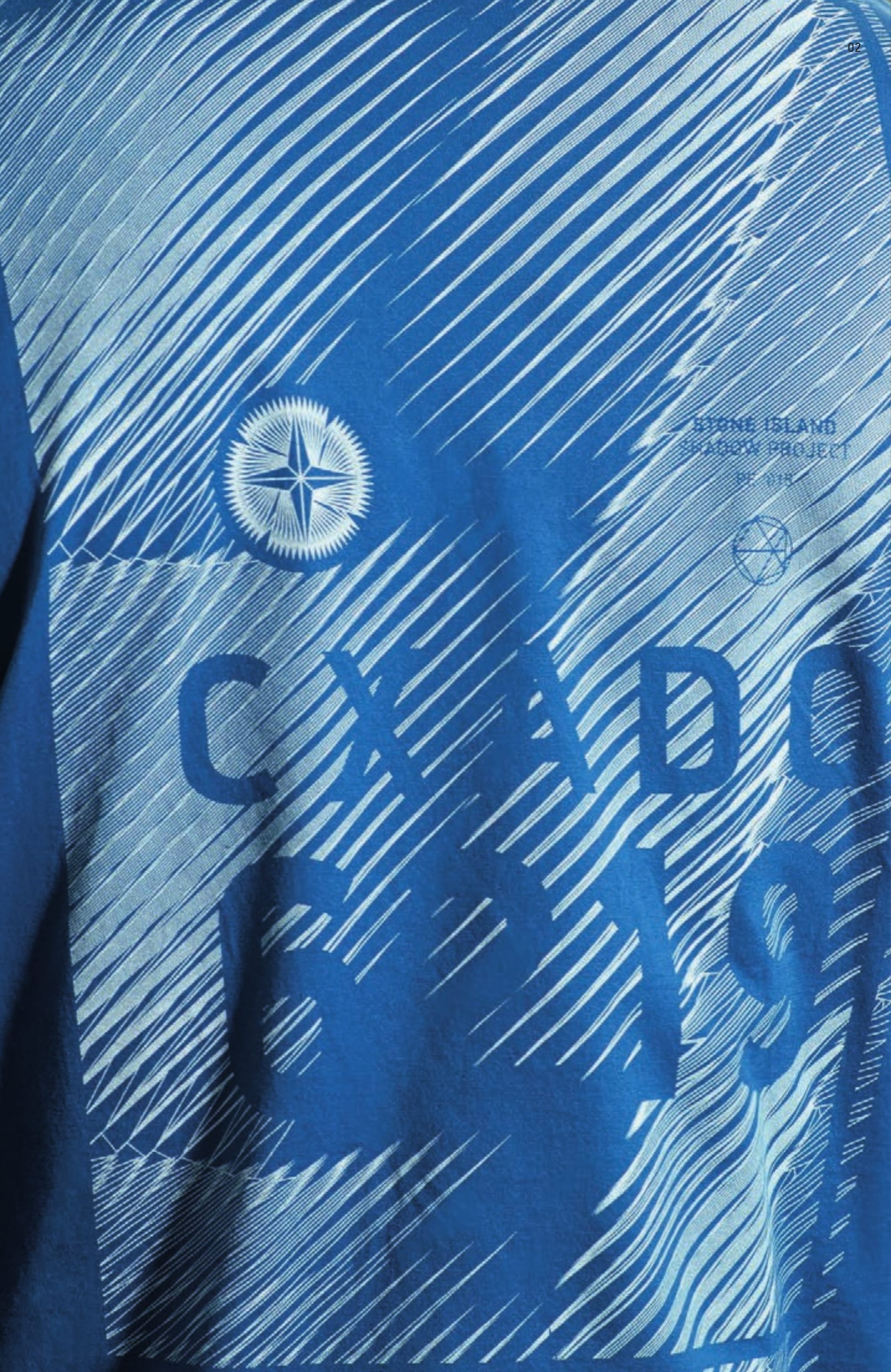 20211 LS T-SHIRT PRINTED _ INTERLOCK MAKO CO Long sleeve T-Shirt in Mako cotton interlock. Garment dyed. Wide and long fit. Ribbed neckline and cuffs. Trapeze shaped ‘Catch pocket’ on chest, with side opening. Print on chest and sleeves. Big 6219 CXADO print on back.