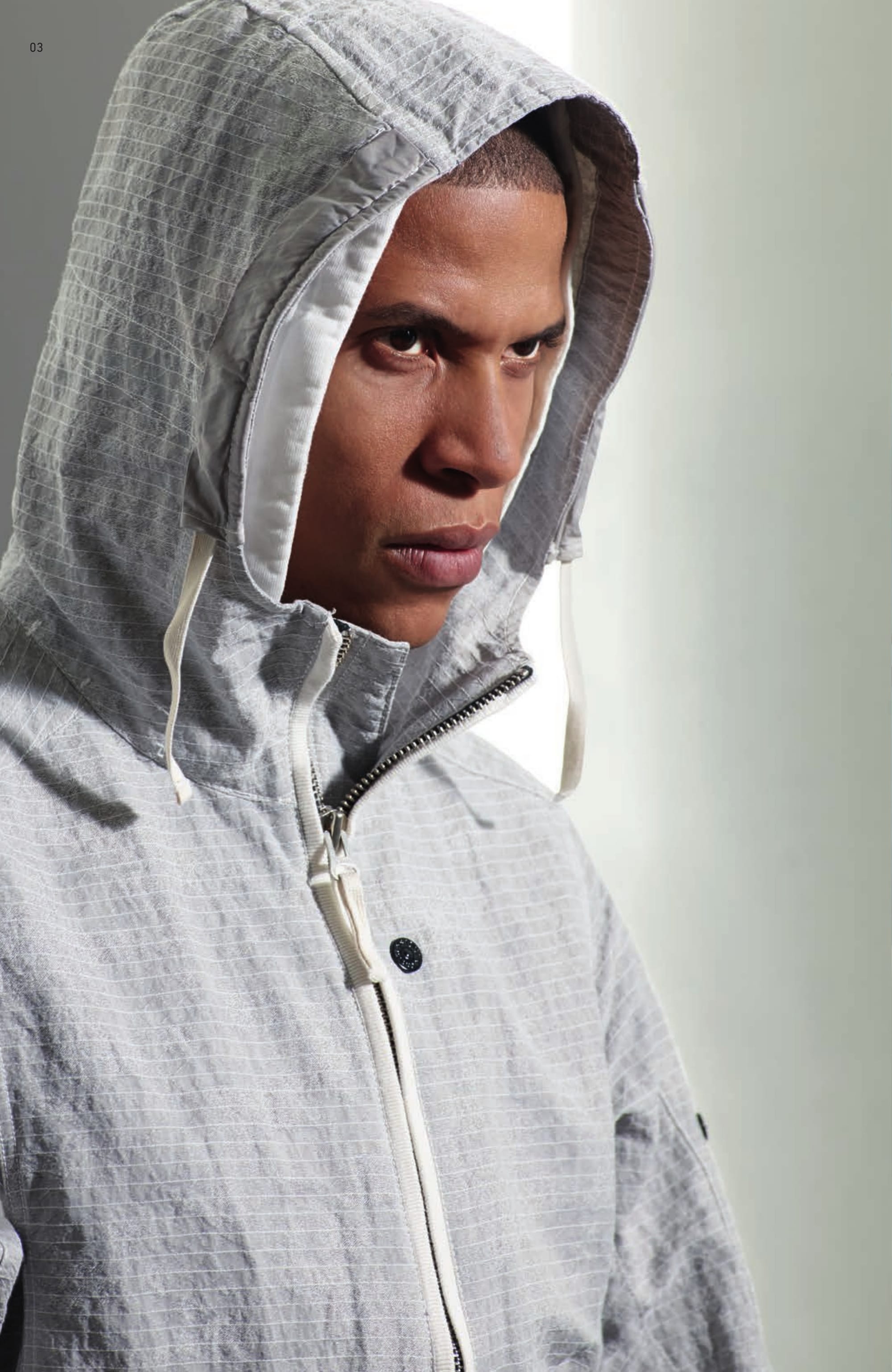 40404 CAGOULE _ DPM GRID JACQUARD Hooded jacket in custom made Stone Island DPM design cotton/nylon jacquard. Garment dyed. It is fitting that industrial age Jacquard looms are regarded by many as a precursor to modern computer science; the resolution and complexity achievable with today’s machines are an elegant reflection of the digital age. The cotton and nylon yarns of DPM GRID JAQUARD are garment dyed separately in complementary or contrasting colours. The results of this dye procedure are spectacularly multi-layered; capturing both high definition contrasts or subtle tonal shading depending on colour combination. Computation rendered in physical wearable form. Drawstring on hood, in hollowcore nylon tunnel. Shaped front bellows pockets with zip fastening edged in cotton jersey. Wide armholes to ease movement. Adjustable straps at shaped cuffs. Two snaps and zip fastening edged in cotton jersey.