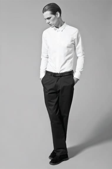 Johannes Niermann in a white narrow-collar shirt and black tailored trousers from Stahl Corporation Fall/Winter 2012.