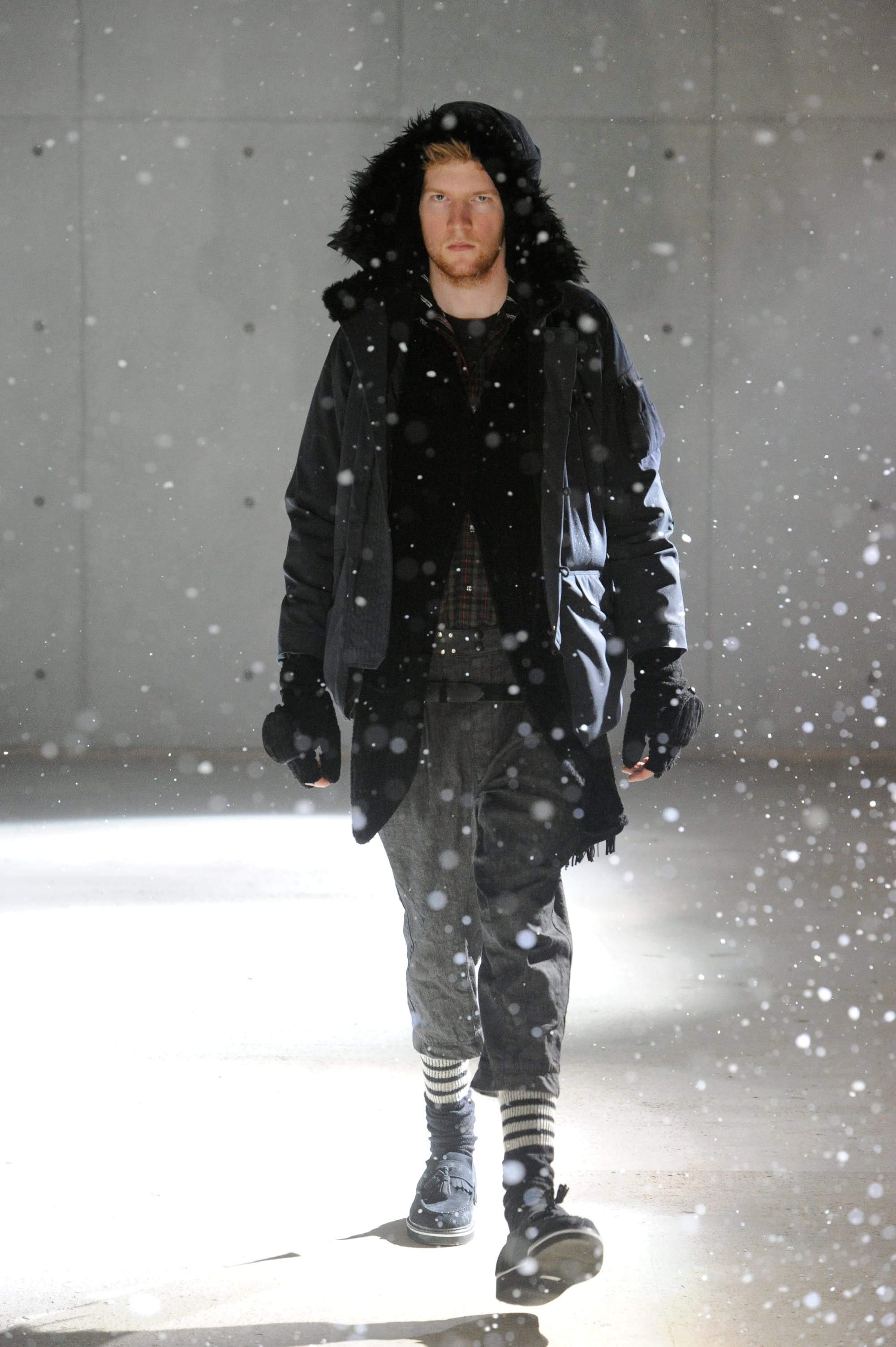 White Mountaineering Wilderness Outfitters look 3: black fur-trimmed hooded parka and layered cropped trousers.