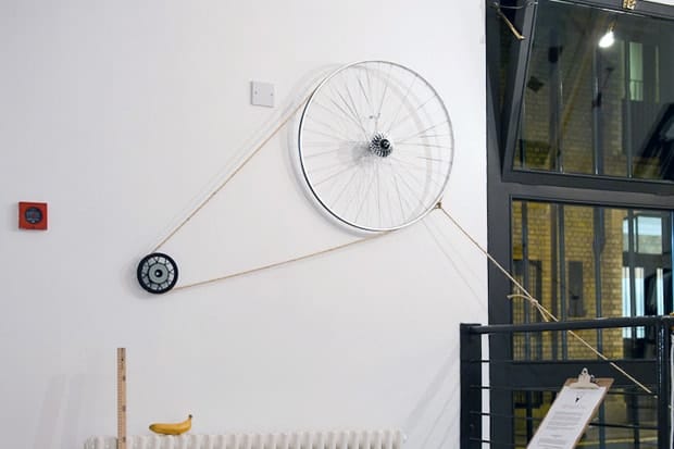Silent Ventures bicycle-wheel and pulley installation mounted on the London pop-up store wall.