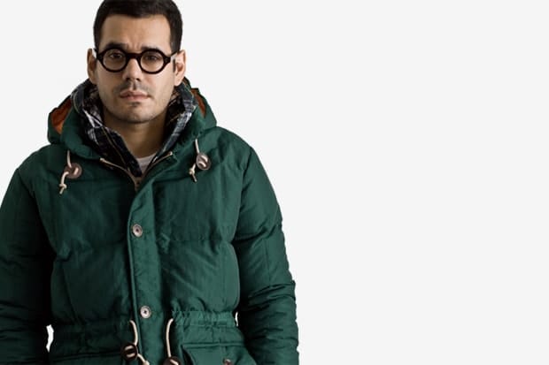 Close-up of a green Stussy Japan Fall 2011 hooded parka with leather drawcord tabs.