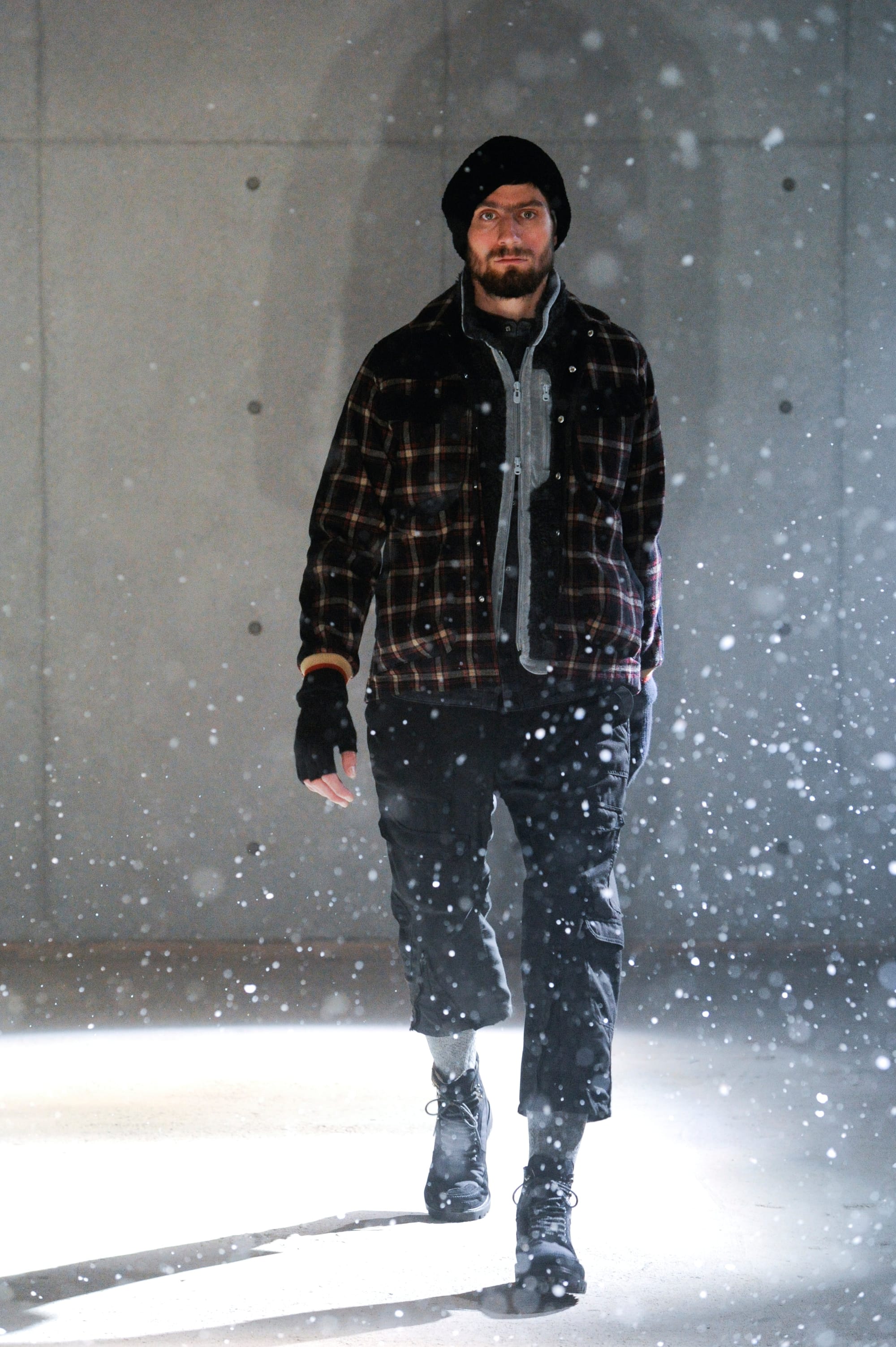 White Mountaineering Wilderness Outfitters look 5: plaid layered field jacket, knit cap and cropped cargo trousers.
