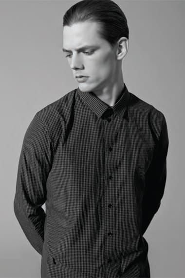 Close portrait of Johannes Niermann in a black micro-check Stahl Corporation shirt.