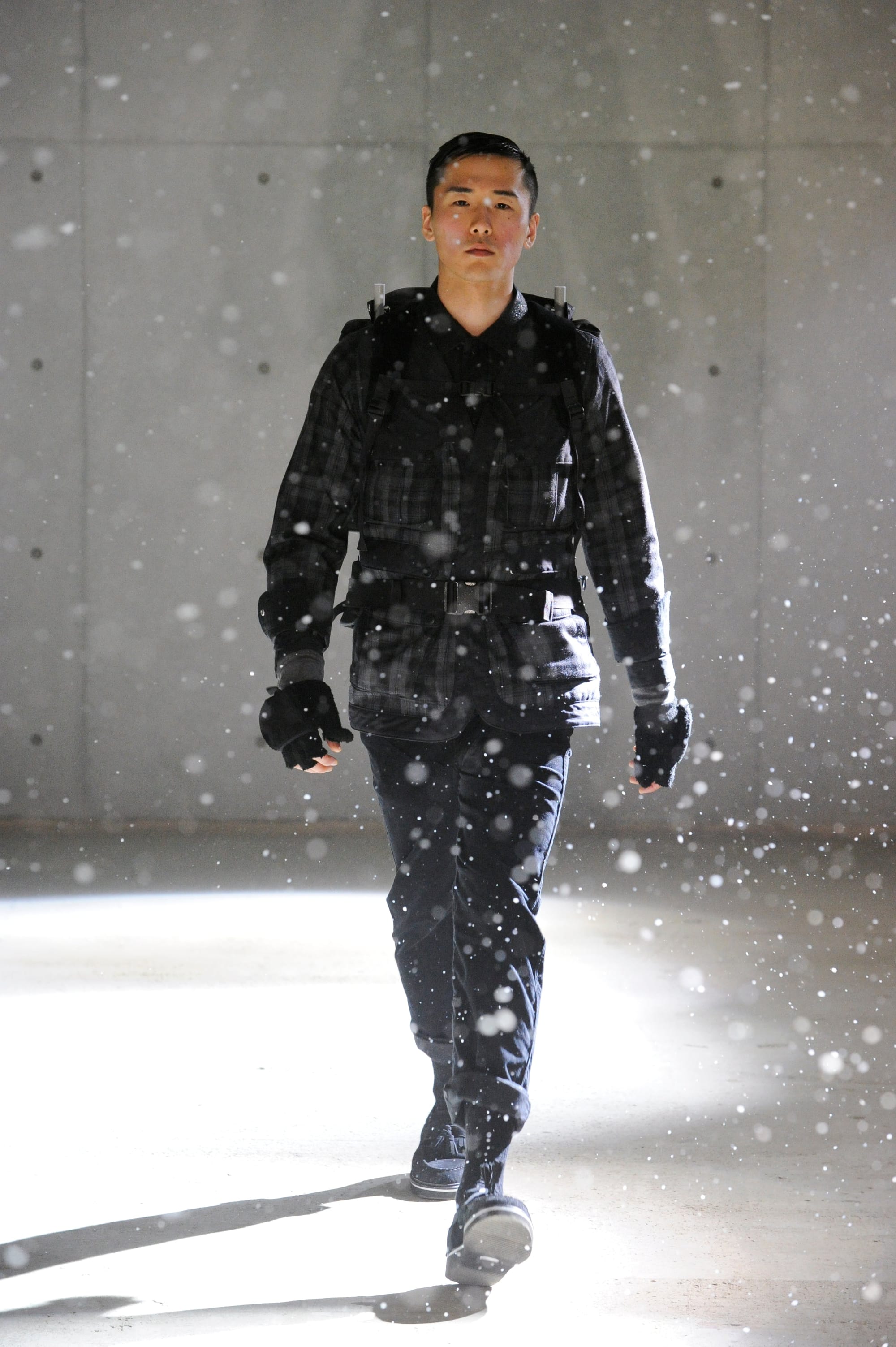 White Mountaineering Wilderness Outfitters look 7: patterned hooded jacket, asymmetric utility pockets and grey trousers.