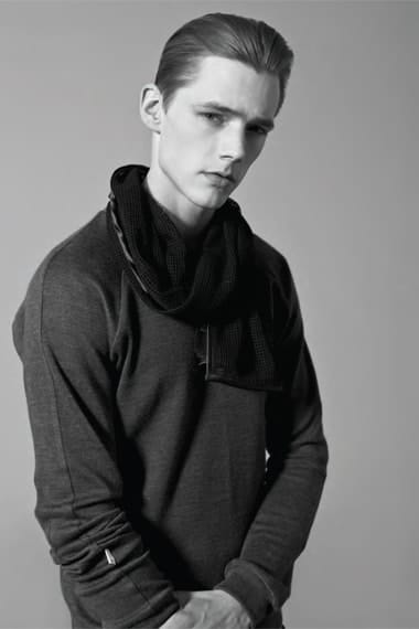 Johannes Niermann in a charcoal knit with a looped scarf from Stahl Corporation.